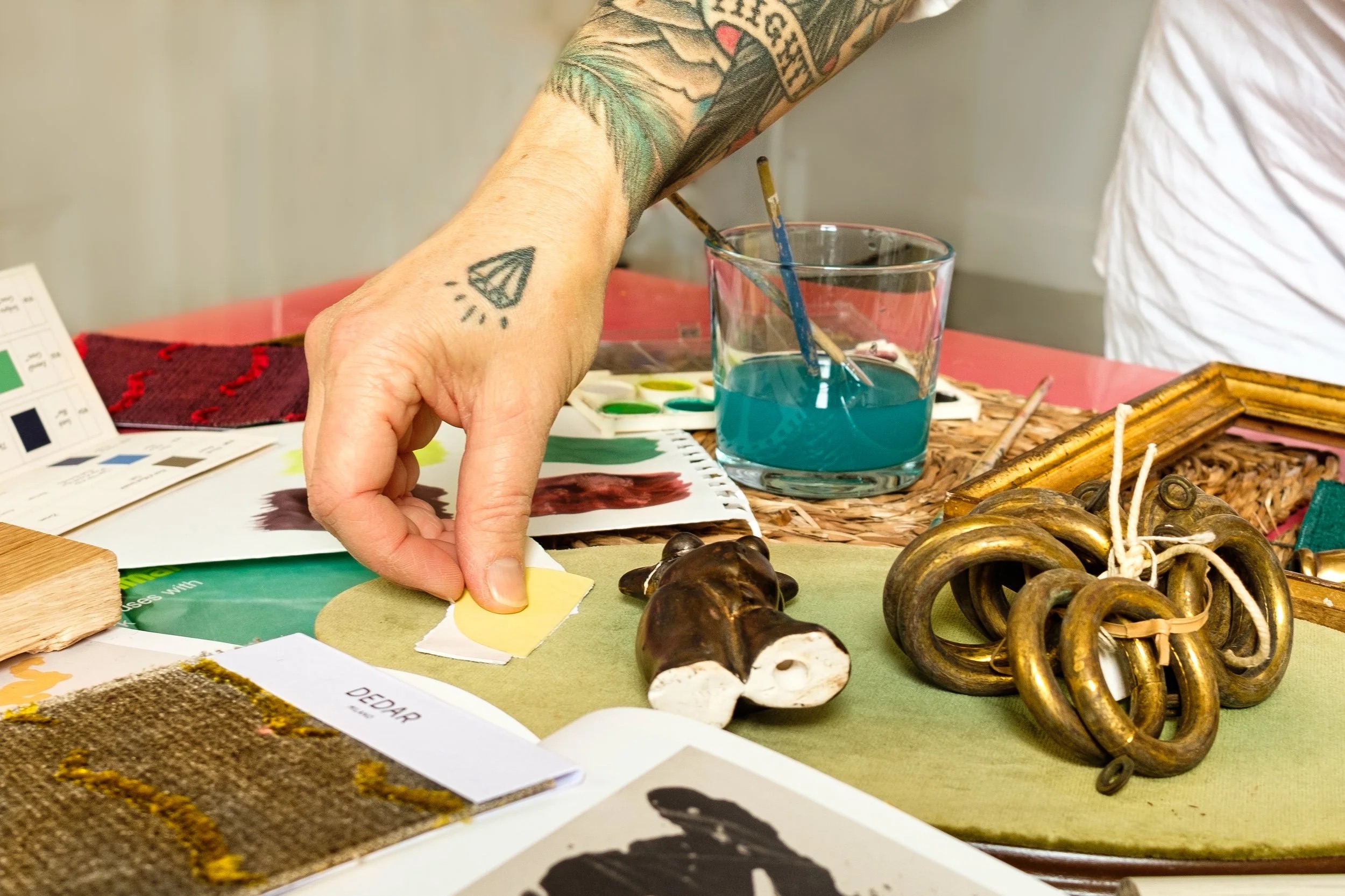 Hallie Goodman selecting paint and fabric samples during a consultation